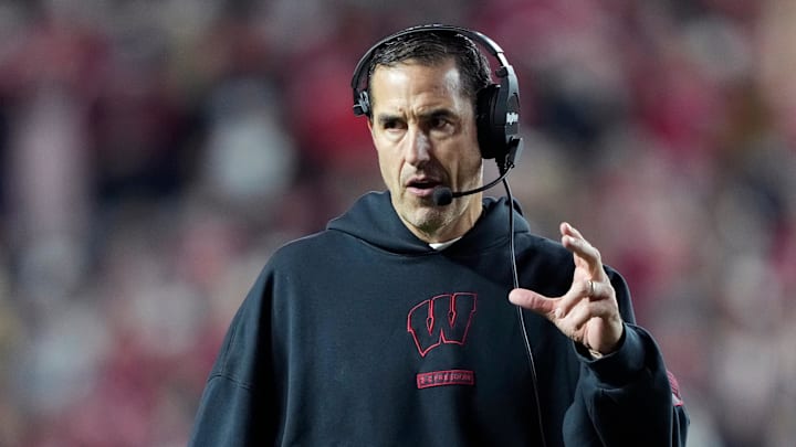 Nov 22, 2025; Madison, Wisconsin, USA; Wisconsin Badgers head coach Luke Fickell talks to his team during the second half against the Illinois Fighting Illini at Camp Randall Stadium. Mandatory Credit: Kayla Wolf-Imagn Images