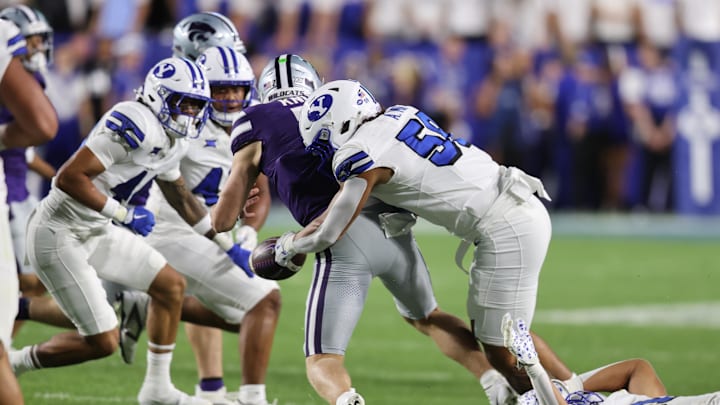 Sep 21, 2024; Provo, Utah, USA; Brigham Young Cougars linebacker Aisea Moa (58) forces a fumble by Kansas State Wildcats quarterback Jacob Knuth (7) during the fourth quarter at LaVell Edwards Stadium. Mandatory Credit: Rob Gray-Imagn Images Sep 21, 2024; Provo, Utah, USA; Brigham Young Cougars linebacker Aisea Moa (58) forces a fumble by Kansas State Wildcats quarterback Jacob Knuth (7) during the fourth quarter at LaVell Edwards Stadium. Mandatory Credit: Rob Gray-Imagn Images