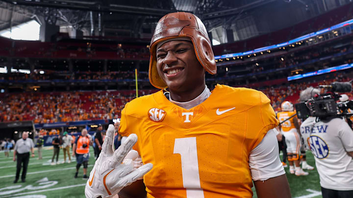 Aug 30, 2025; Atlanta, Georgia, USA; Tennessee Volunteers wide receiver Travis Smith Jr. (1) celebrates with the old leather helmet after a victory against the Syracuse Orange at Mercedes-Benz Stadium. Mandatory Credit: Brett Davis-Imagn Images