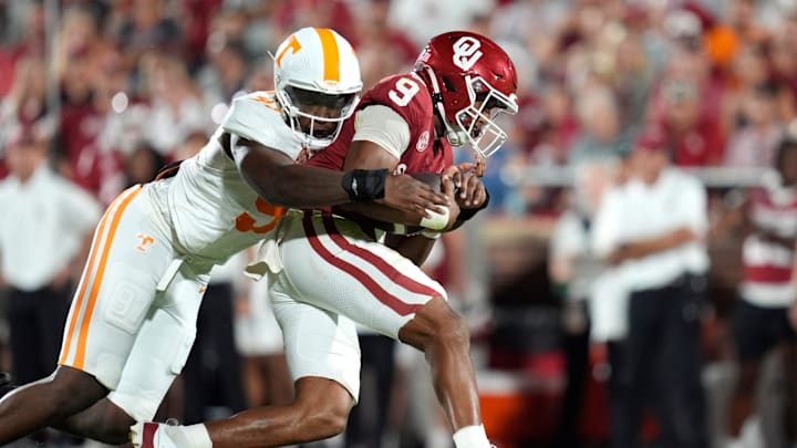Oklahoma Sooners quarterback Michael Hawkins Jr. (9) is brought down by Tennessee Volunteers defensive lineman Jayson Jenkins (97) during a college football game between the University of Oklahoma Sooners (OU) and the Tennessee Volunteers at Gaylord Family - Oklahoma Memorial Stadium in Norman, Okla., Saturday, Sept. 21, 2024.