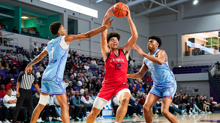 Columbus Explorers forward Cameron Boozer (12) is fouled by IMG Academy Ascenders forward Sadiq White Jr. (1) during the first quarter of the City of Palms Classic semifinal game at Suncoast Credit Union Arena in Fort Myers, Fla., on Saturday, Dec. 21, 2024.