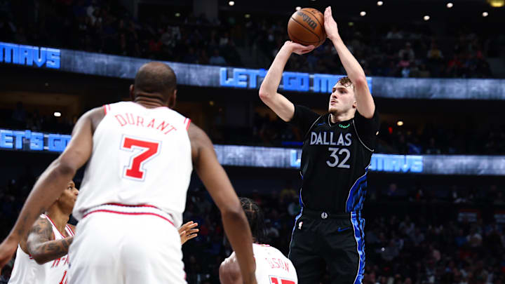 Jan 3, 2026; Dallas, Texas, USA; Dallas Mavericks forward Cooper Flagg (32) shoots over Houston Rockets forward Tari Eason (17) and Houston Rockets forward Kevin Durant (7) during the second half at American Airlines Center. Mandatory Credit: Kevin Jairaj-Imagn Images
