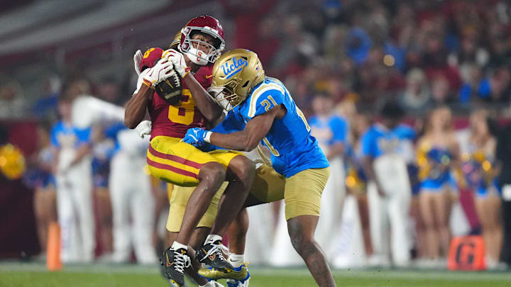 Nov 29, 2025; Los Angeles, California, USA; Southern California Trojans wide receiver Ja'Kobi Lane (8) catches the ball against UCLA Bruins defensive back Cole Martin (21) in the second half at United Airlines Field at Los Angeles Memorial Coliseum. Mandatory Credit: Kirby Lee-Imagn Images