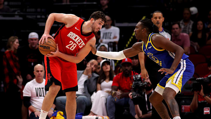 Nov 2, 2024; Houston, Texas, USA; Houston Rockets center Alperen Sengun (28) handles the ball against Golden State Warriors forward Kevon Looney (5) during the game at Toyota Center. Mandatory Credit: Erik Williams-Imagn Images
