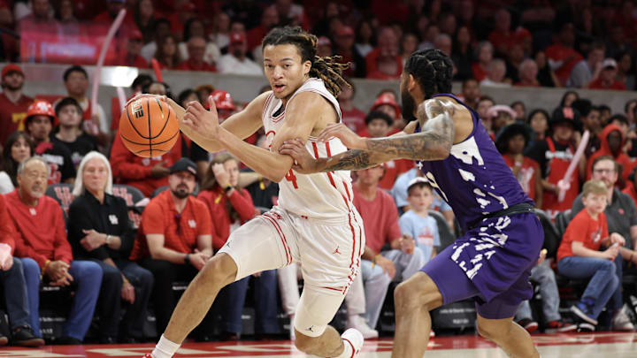 Feb 14, 2026; Houston, Texas, USA; Houston Cougars guard Kingston Flemings (4) drives to the net against Kansas State Wildcats guard David Castillo (10)  in the first half at Fertitta Center. Mandatory Credit: Thomas Shea-Imagn Images