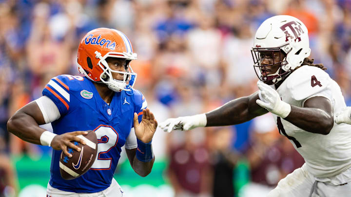 Sep 14, 2024; Gainesville, Florida, USA; Florida Gators quarterback DJ Lagway (2) evades Texas A&M Aggies defensive lineman Shemar Stewart (4) during the first half at Ben Hill Griffin Stadium. Mandatory Credit: Matt Pendleton-Imagn Images