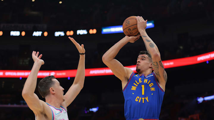 Jan 17, 2025; Miami, Florida, USA; Denver Nuggets forward Michael Porter Jr. (1) shoots the basketball over Miami Heat forward Duncan Robinson (55) during the first quarter at Kaseya Center. Mandatory Credit: Sam Navarro-Imagn Images