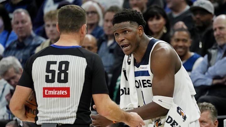 Feb 3, 2025; Minneapolis, Minnesota, USA; Minnesota Timberwolves guard Anthony Edwards (5) has a discussion with referee Josh Tiven about a call in the fourth quarter of the game with the Sacramento Kings at Target Center. Mandatory Credit: Bruce Kluckhohn-Imagn Images