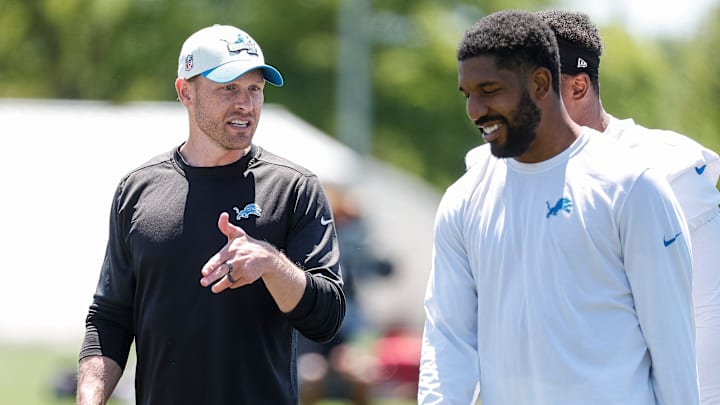 Detroit Lions offensive coordinator Ben Johnson talks to linebacker Jalen Reeves-Maybin (42) after practice during OTAs at Detroit Lions headquarters and training facility in Allen Park on Thursday, May 30, 2024.