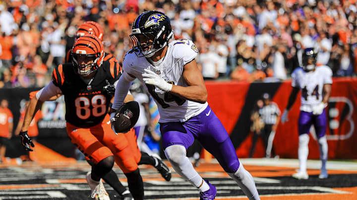 Oct 6, 2024; Cincinnati, Ohio, USA; Baltimore Ravens safety Kyle Hamilton (14) runs with the ball against Cincinnati Bengals tight end Mike Gesicki (88) in the first half at Paycor Stadium. Mandatory Credit: Katie Stratman-Imagn Images