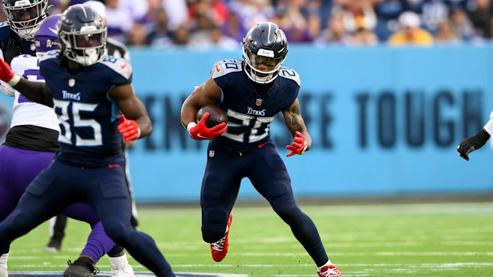 Nov 17, 2024; Nashville, Tennessee, USA;  Tennessee Titans running back Tony Pollard (20) runs the ball against the Minnesota Viking during the second half during the first half at Nissan Stadium. Mandatory Credit: Steve Roberts-Imagn Images