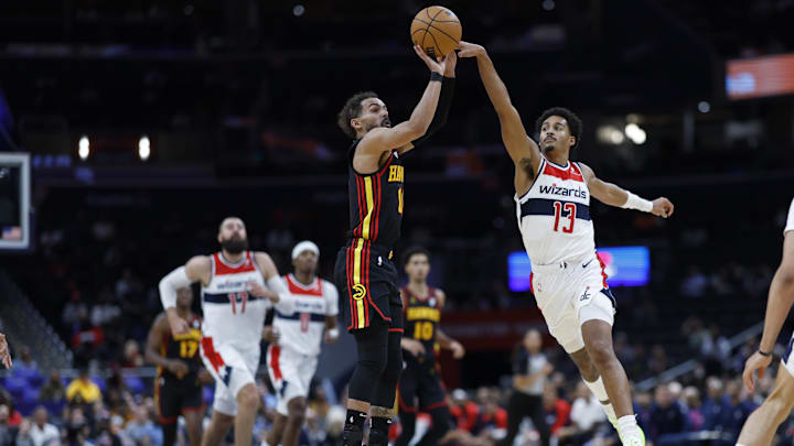 Oct 30, 2024; Washington, District of Columbia, USA; Atlanta Hawks guard Trae Young (11) shoots the ball as Washington Wizards guard Jordan Poole (13) defends in the first half at Capital One Arena. Mandatory Credit: Geoff Burke-Imagn Images
