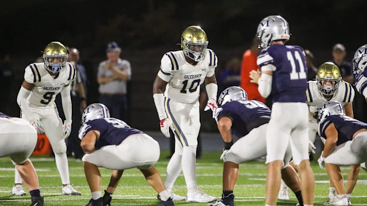 Salesianum defenders, including L.J. Smith (9), R.J. Johnson (10) and Tyler Frampton (right) wait for the snap in the second half of Malvern Prep's 27-3 win at Abessinio Stadium, Friday, Sept. 20, 2024.