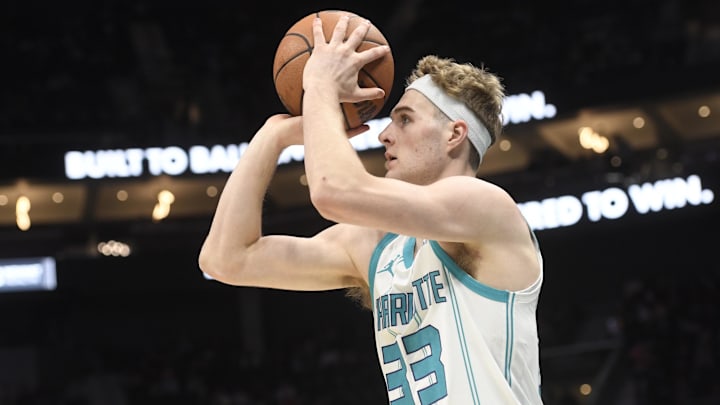 Dec 7, 2025; Charlotte, North Carolina, USA; Charlotte Hornets forward Liam McNeeley (33) looks to shoot for 3 points during the first half against the Denver Nuggets at the Spectrum Center.