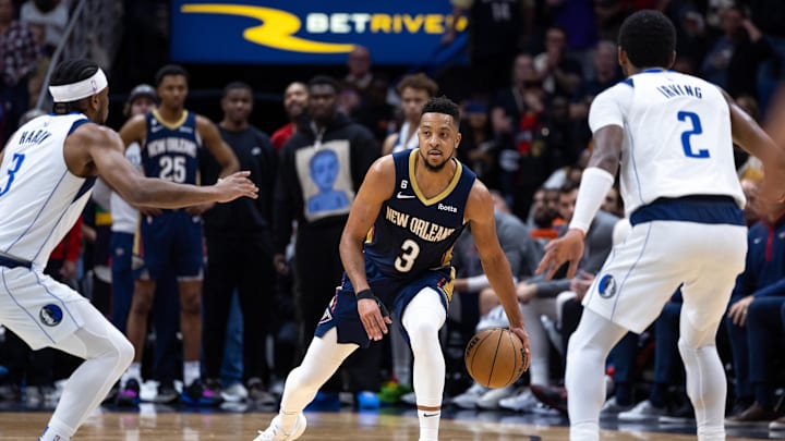 Mar 8, 2023; New Orleans, Louisiana, USA;  New Orleans Pelicans guard CJ McCollum (3) brings the ball up court against Dallas Mavericks guard Kyrie Irving (2) and guard Jaden Hardy (3) during the second half at Smoothie King Center. Mandatory Credit: Stephen Lew-Imagn Images