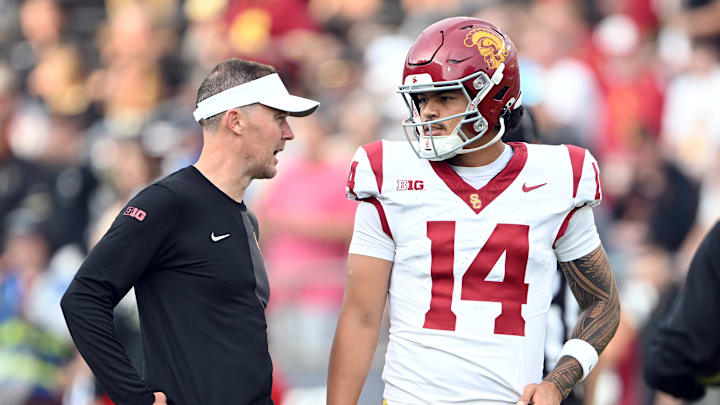 Sep 13, 2025; West Lafayette, Indiana, USA;  Southern California Trojans quarterback Jayden Maiava (14) talks with Southern California Trojans head coach Lincoln Riley  before the game against the Purdue Boilermakers at Ross-Ade Stadium. Mandatory Credit: Marc Lebryk-Imagn Images