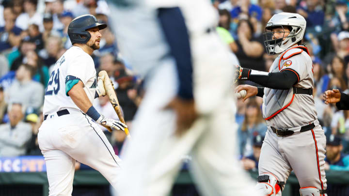 Seattle Mariners catcher Cal Raleigh (29) strikes out to en the sixth inning at T-Mobile Park. Baltimore Orioles catcher Adley Rutschman (35) stands at right on July 2.