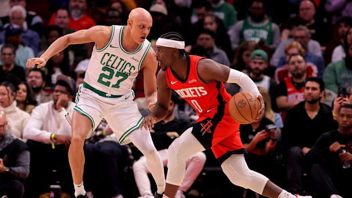 Jan 3, 2025; Houston, Texas, USA; Houston Rockets guard Aaron Holiday (0) handles the ball against Boston Celtics guard Jordan Walsh (27) during the game at Toyota Center. Mandatory Credit: Erik Williams-Imagn Images