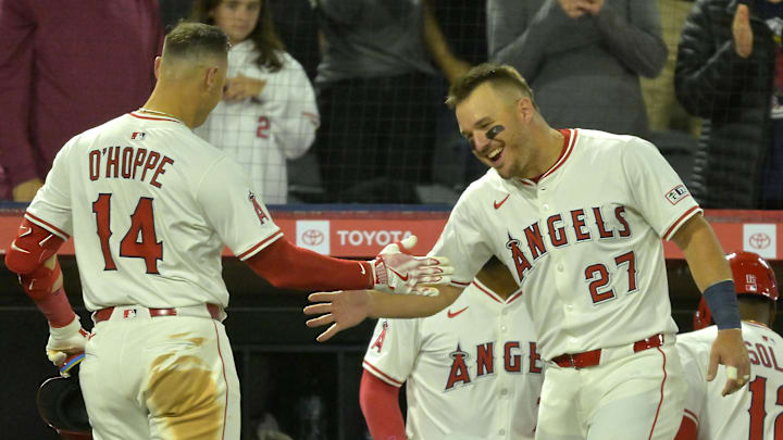 Apr 5, 2025; Anaheim, California, USA;  Los Angeles Angels catcher Logan O'Hoppe (14) is congratulated at the dugout by center fielder Mike Trout (27) after hitting a two-run home run in the fifth inning against the Cleveland Guardians at Angel Stadium. Mandatory Credit: Jayne Kamin-Oncea-Imagn Images