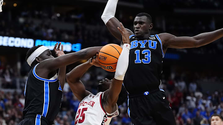 Mar 22, 2025; Denver, CO, USA; Wisconsin Badgers guard John Blackwell (25) dribbles the ball against Brigham Young Cougars forward Mawot Mag (0) and center Keba Keita (13) during the second half in the first round of the NCAA Tournament  at Ball Arena. Mandatory Credit: Ron Chenoy-Imagn Images