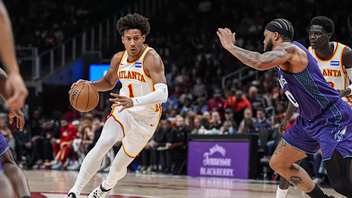 Nov 23, 2025; Atlanta, Georgia, USA; Atlanta Hawks forward Jalen Johnson (1) drives with the ball against Charlotte Hornets forward Miles Bridges (0) during the first half at State Farm Arena. Mandatory Credit: Dale Zanine-Imagn Images