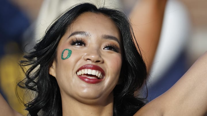Nov 2, 2024; Ann Arbor, Michigan, USA; Oregon Ducks cheerleader cheers in the first half against the Michigan Wolverines at Michigan Stadium. Mandatory Credit: Rick Osentoski-Imagn Images Nov 2, 2024; Ann Arbor, Michigan, USA; Oregon Ducks cheerleader cheers in the first half against the Michigan Wolverines at Michigan Stadium. Mandatory Credit: Rick Osentoski-Imagn Images