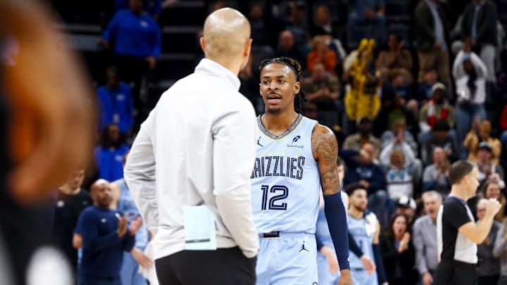 Dec 13, 2024; Memphis, Tennessee, USA; Memphis Grizzlies guard Ja Morant (12) reacts toward Brooklyn Nets head coach Jordi Fernandez, after a buzzer beating basket at the end of the second quarter at FedExForum. Mandatory Credit: Petre Thomas-Imagn Images
