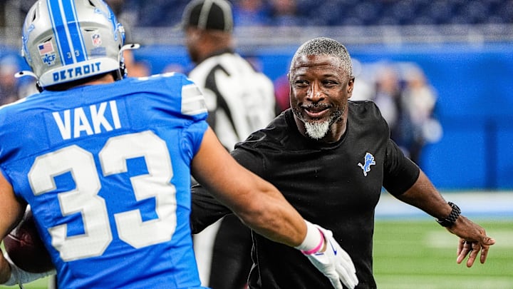 Detroit Lions defensive coordinator Aaron Glenn shakes hands with running back Sione Vaki (33) during warm up before the Tennessee Titans game at Ford Field in Detroit on Sunday, Oct. 27, 2024. Detroit Lions defensive coordinator Aaron Glenn shakes hands with running back Sione Vaki (33) during warm up before the Tennessee Titans game at Ford Field in Detroit on Sunday, Oct. 27, 2024.