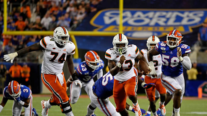 Aug 24, 2019; Orlando, FL, USA; Miami Hurricanes running back DeeJay Dallas (13) runs the ball for a touchdown against the Florida Gators during the second half at Camping World Stadium. Mandatory Credit: Jasen Vinlove-USA TODAY Sports