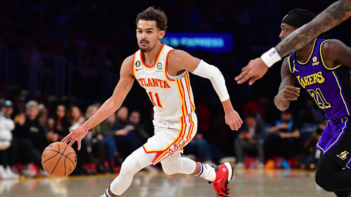 Jan 6, 2023; Los Angeles, California, USA; Atlanta Hawks guard Trae Young (11) moves the ball ahead of Los Angeles Lakers guard Patrick Beverley (21) during the first half at Crypto.com Arena. Mandatory Credit: Gary A. Vasquez-Imagn Images