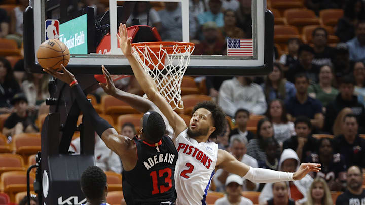 Mar 5, 2024; Miami, Florida, USA; Detroit Pistons guard Cade Cunningham (2) defends Miami Heat center Bam Adebayo (13) during the first half at Kaseya Center. Mandatory Credit: Rhona Wise-Imagn Images