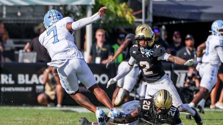 Sep 20, 2025; Orlando, Florida, USA; UCF Knights wide receiver Duane Thomas Jr. (7) is tackled by UCF Knights linebacker Lewis Carter (20) during the second quarter at the Bounce House Stadium. Sep 20, 2025; Orlando, Florida, USA; UCF Knights wide receiver Duane Thomas Jr. (7) is tackled by UCF Knights linebacker Lewis Carter (20) during the second quarter at the Bounce House Stadium.