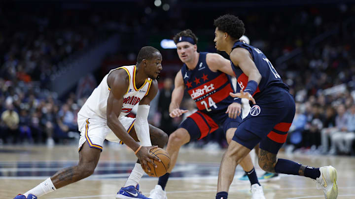 Nov 4, 2024; Washington, District of Columbia, USA; Golden State Warriors forward Jonathan Kuminga (00) drives to the basket as Washington Wizards forward Corey Kispert (24) and Wizards guard Jordan Poole (13) defend in the second half at Capital One Arena. Mandatory Credit: Geoff Burke-Imagn Images
