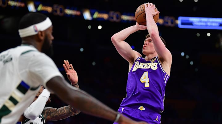 Jan 9, 2026; Los Angeles, California, USA; Los Angeles Lakers forward Dalton Knecht (4) shoots against the Milwaukee Bucks during the second half at Crypto.com Arena. Mandatory Credit: Gary A. Vasquez-Imagn Images