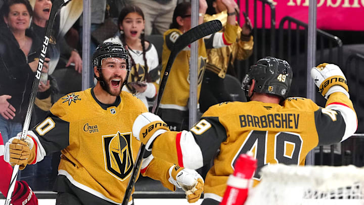 Mar 22, 2025; Las Vegas, Nevada, USA; Vegas Golden Knights center Nicolas Roy (10) celebrates with Vegas Golden Knights center Ivan Barbashev (49) after scoring a goal against the Detroit Red Wings during the first period at T-Mobile Arena. Mandatory Credit: Stephen R. Sylvanie-Imagn Images