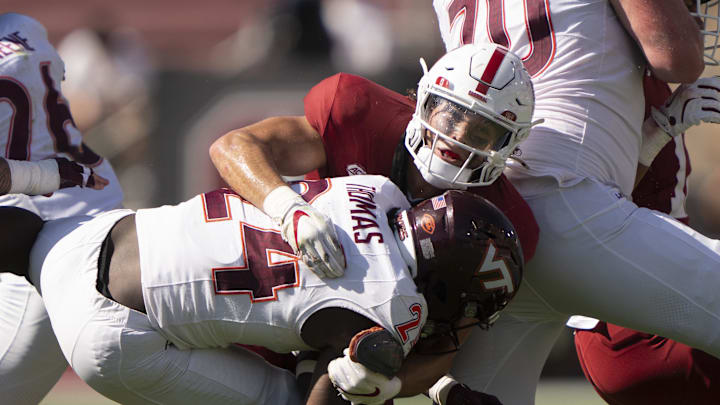 Oct 5, 2024; Stanford, California, USA;  Stanford Cardinal linebacker Tristan Sinclair (8) tackles Virginia Tech Hokies running back Malachi Thomas (24) during the third quarter  at Stanford Stadium. Mandatory Credit: Stan Szeto-Imagn Images