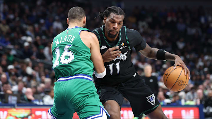 Jan 28, 2026; Dallas, Texas, USA;  Minnesota Timberwolves center Naz Reid (11) dribbles as Dallas Mavericks forward Caleb Martin (16) defends at American Airlines Center. Mandatory Credit: Kevin Jairaj-Imagn Images