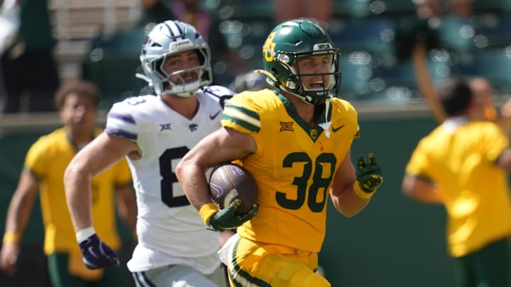 Oct 4, 2025; Waco, Texas, USA; Baylor Bears safety Jacob Redding (38) returns an interception for a touchdown against Kansas State Wildcats tight end Will Swanson (83) during the second half at McLane Stadium. Mandatory Credit: Chris Jones-Imagn Images