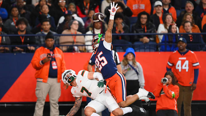 Nov 30, 2024; Syracuse, New York, USA; Syracuse Orange defensive back Davien Kerr (25) breaks up a pass intended for Miami Hurricanes wide receiver Xavier Restrepo (7) during the first half at the JMA Wireless Dome. Defensive pass interference was called on the play. 