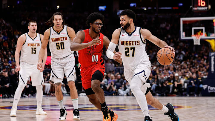 Feb 4, 2024; Denver, Colorado, USA; Denver Nuggets guard Jamal Murray (27) controls the ball against Portland Trail Blazers guard Scoot Henderson (00) as forward Aaron Gordon (50) and center Nikola Jokic (15) defend in the second quarter at Ball Arena. Mandatory Credit: Isaiah J. Downing-Imagn Images