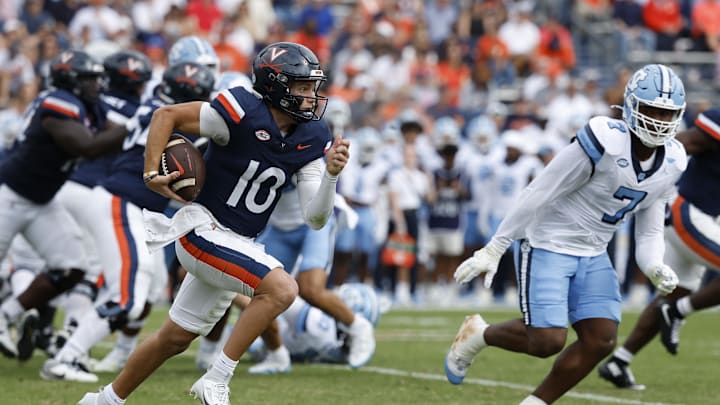 Oct 26, 2024; Charlottesville, Virginia, USA; Virginia Cavaliers quarterback Anthony Colandrea (10) runs with the ball as North Carolina Tar Heels defensive end Kaimon Rucker (7) chases during the first half at Scott Stadium. Mandatory Credit: Geoff Burke-Imagn Images Oct 26, 2024; Charlottesville, Virginia, USA; Virginia Cavaliers quarterback Anthony Colandrea (10) runs with the ball as North Carolina Tar Heels defensive end Kaimon Rucker (7) chases during the first half at Scott Stadium. Mandatory Credit: Geoff Burke-Imagn Images