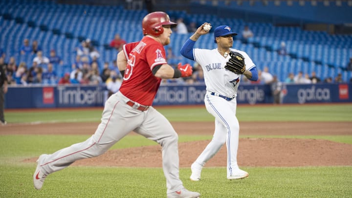 Jun 18, 2019; Toronto, Ontario, CAN; Toronto Blue Jays starting pitcher Marcus Stroman (6) throws out Los Angeles Angels right fielder Kole Calhoun (56) at first base during the seventh inning at Rogers Centre. Mandatory Credit: Nick Turchiaro-Imagn Images