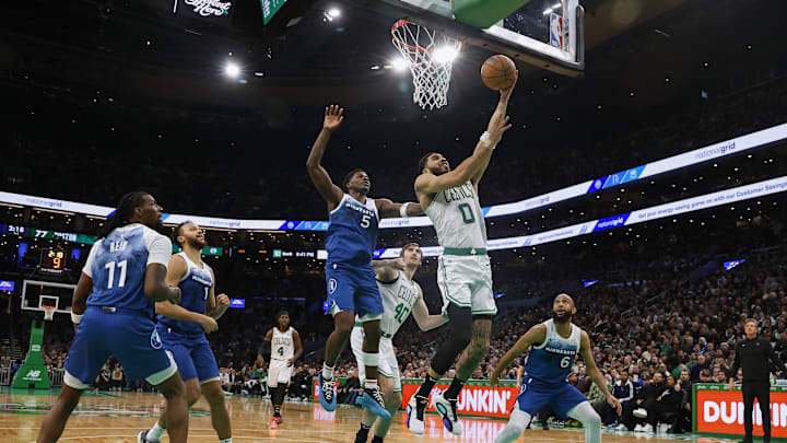 Boston Celtics forward Jayson Tatum goes to the basket past Minnesota Timberwolves guard Anthony Edwards during the second half at of a January 2024 game at TD Garden.