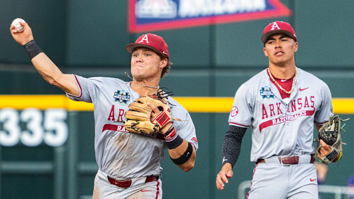 Jun 18, 2025; Omaha, Neb, USA; Arkansas Razorbacks second baseman Cam Kozeal (8) throws to first during the second inning against the LSU Tigers at Charles Schwab Field. Mandatory Credit: Dylan Widger-Imagn Images