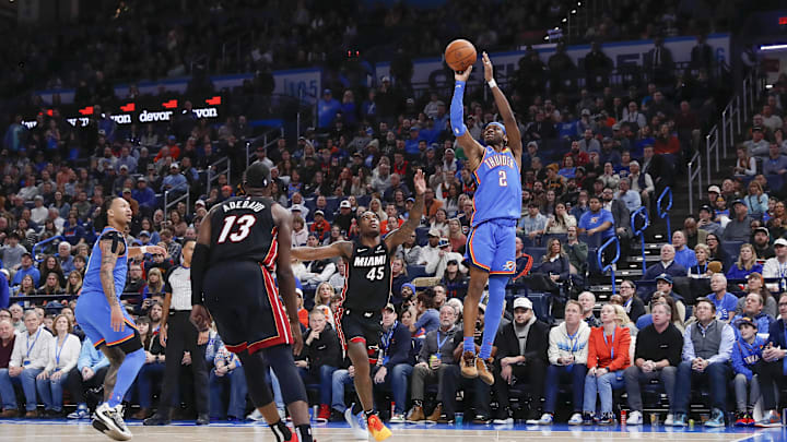 Oklahoma City Thunder guard Shai Gilgeous-Alexander (2) shoots as Miami Heat guard Davion Mitchell (45) defends during the second half at Paycom Center.