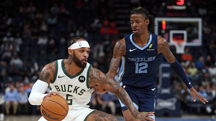 Oct 31, 2024; Memphis, Tennessee, USA; Milwaukee Bucks guard Gary Trent Jr. (5) dribbles as Memphis Grizzlies guard Ja Morant (12) defends during the first half at FedExForum. Mandatory Credit: Petre Thomas-Imagn Images