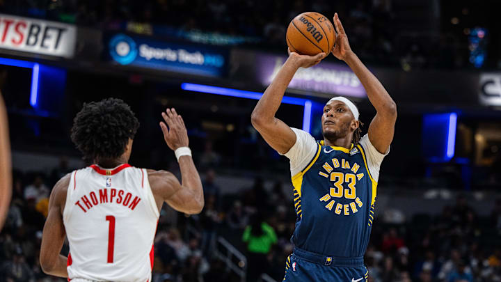 Feb 6, 2024; Indianapolis, Indiana, USA; Indiana Pacers center Myles Turner (33) shoots the ball while Houston Rockets forward Amen Thompson (1) defends in the second half at Gainbridge Fieldhouse. Mandatory Credit: Trevor Ruszkowski-Imagn Images