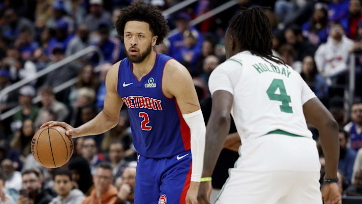 Feb 26, 2025; Detroit, Michigan, USA;  Detroit Pistons guard Cade Cunningham (2) defended by Boston Celtics guard Jrue Holiday (4) in the second half at Little Caesars Arena. Mandatory Credit: Rick Osentoski-Imagn Images