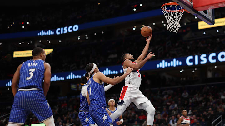 Nov 1, 2025; Washington, District of Columbia, USA; Washington Wizards guard CJ McCollum (3) shoots the ball as Orlando Magic guard Anthony Black (0) looks on in the second half at Capital One Arena. Mandatory Credit: Geoff Burke-Imagn Images