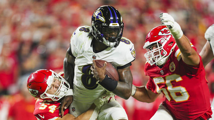 Baltimore Ravens quarterback Lamar Jackson is tackled by Kansas City Chiefs linebacker Leo Chenal.